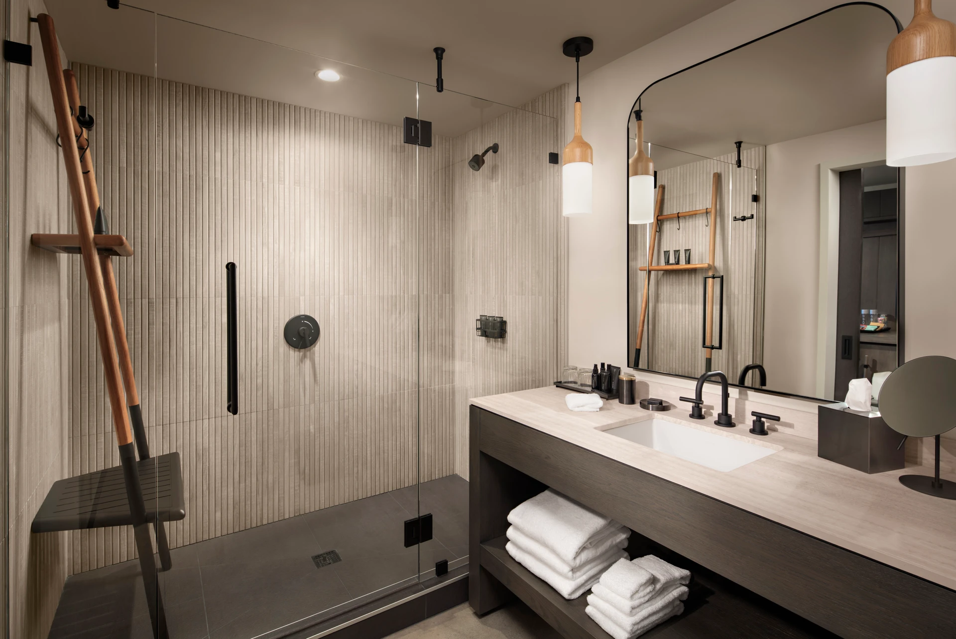 A room bathroom shower and sink area.