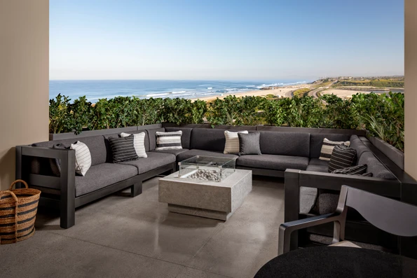 The outdoor terrace with large sofa sectional surrounding the fire pit.