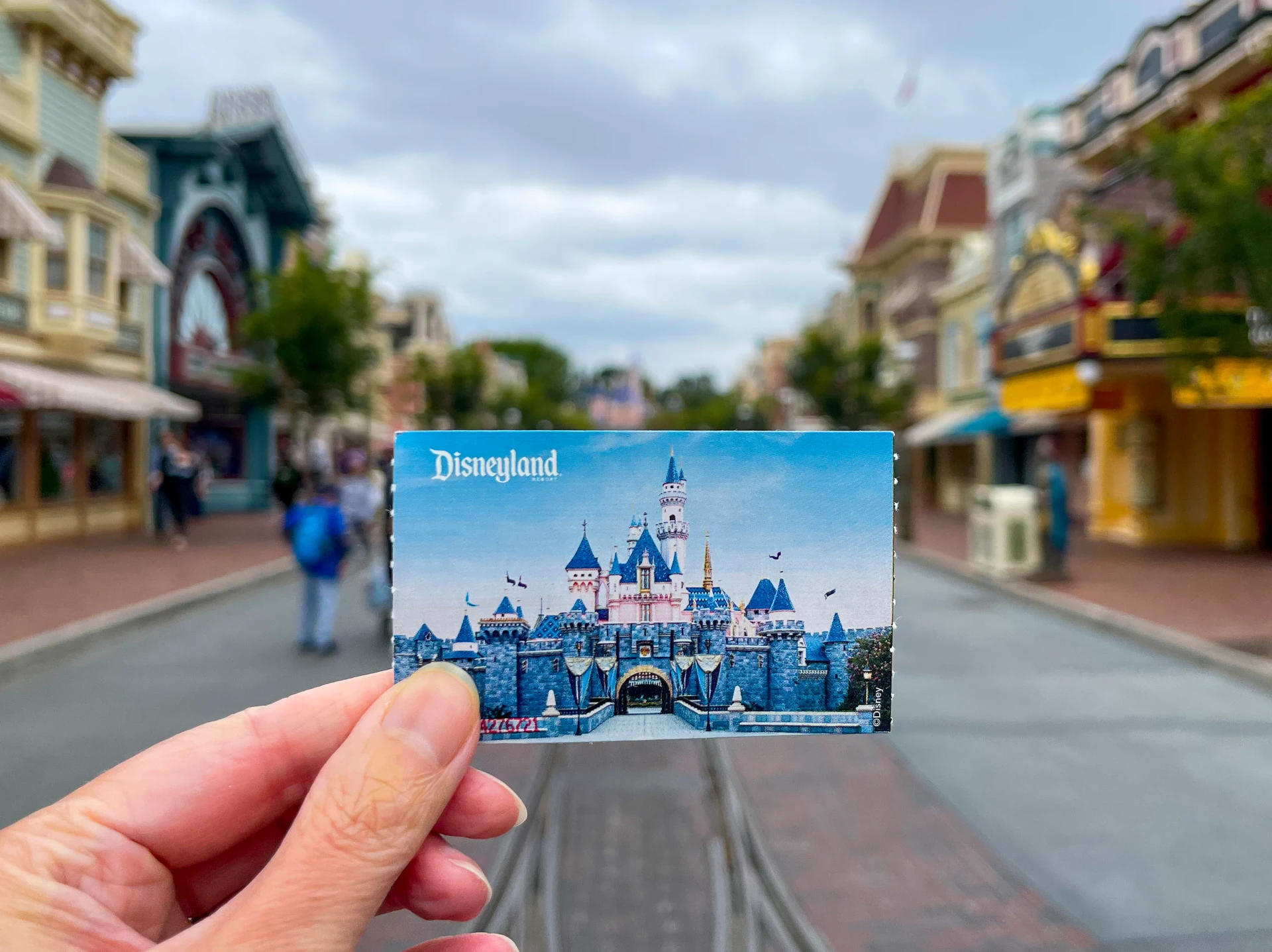 Hand holding Disneyland park ticket