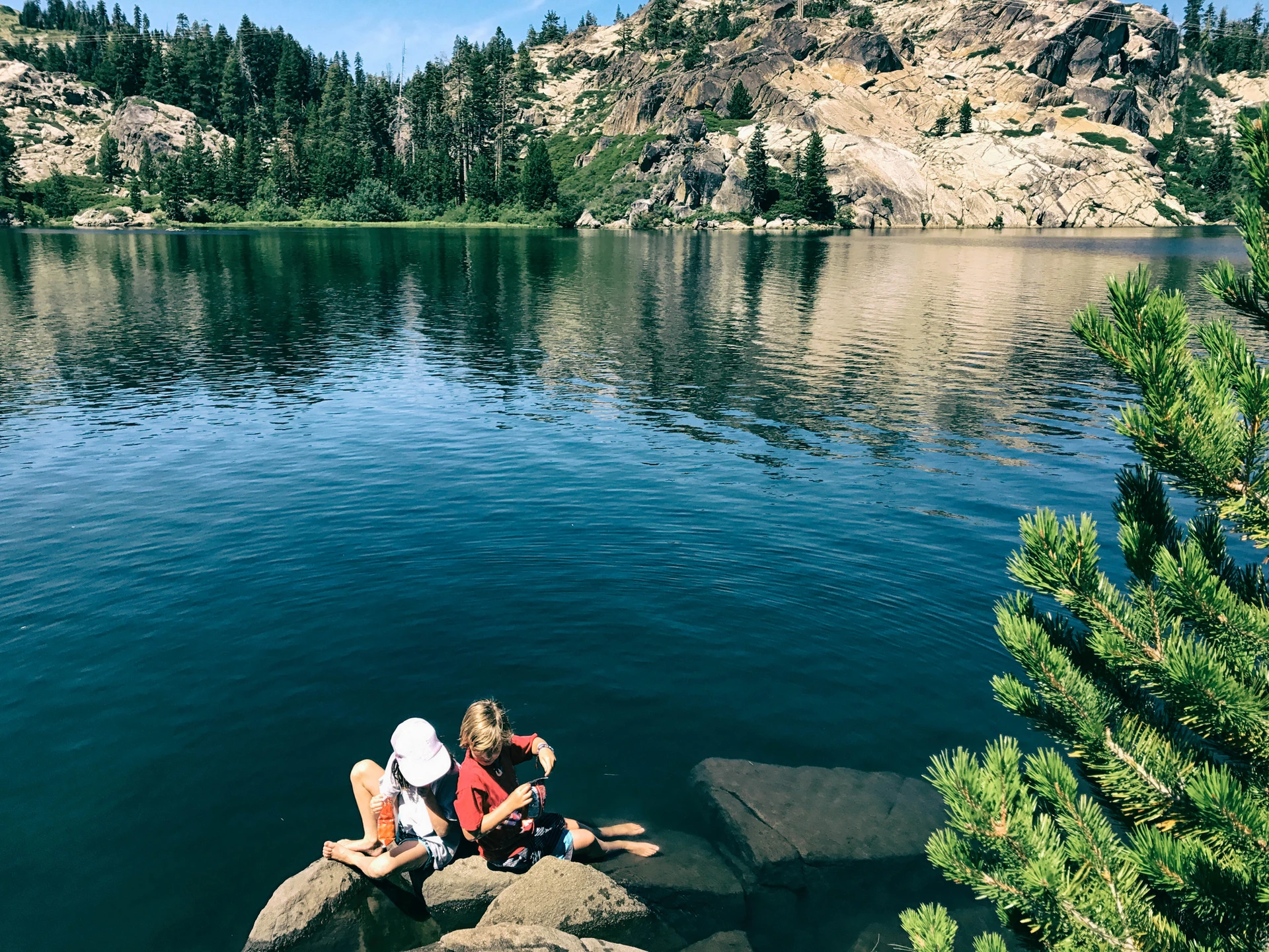 Two kids play by the water at Lake Tahoe.