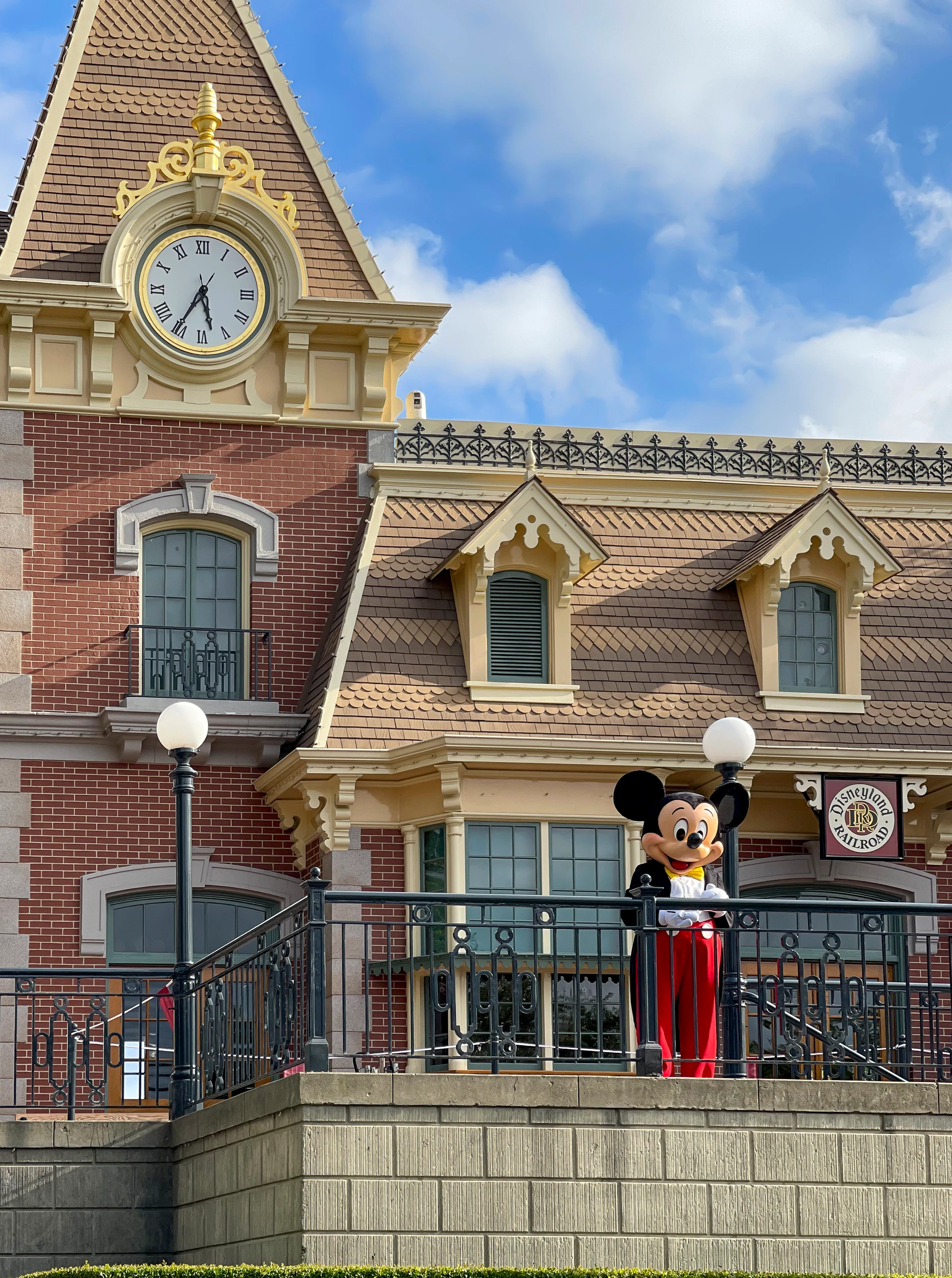 Mickey Mouse greets guests from the Disneyland Railroad station.