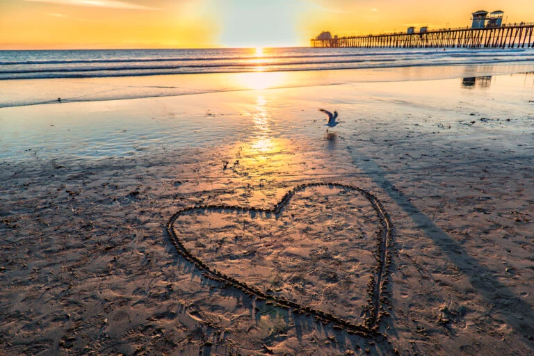 A heart drawn in the sand on Oceanside beach near the pierl