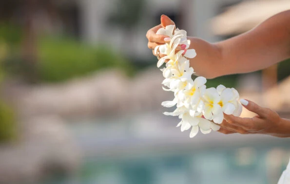 A women holds a fresh flower lei