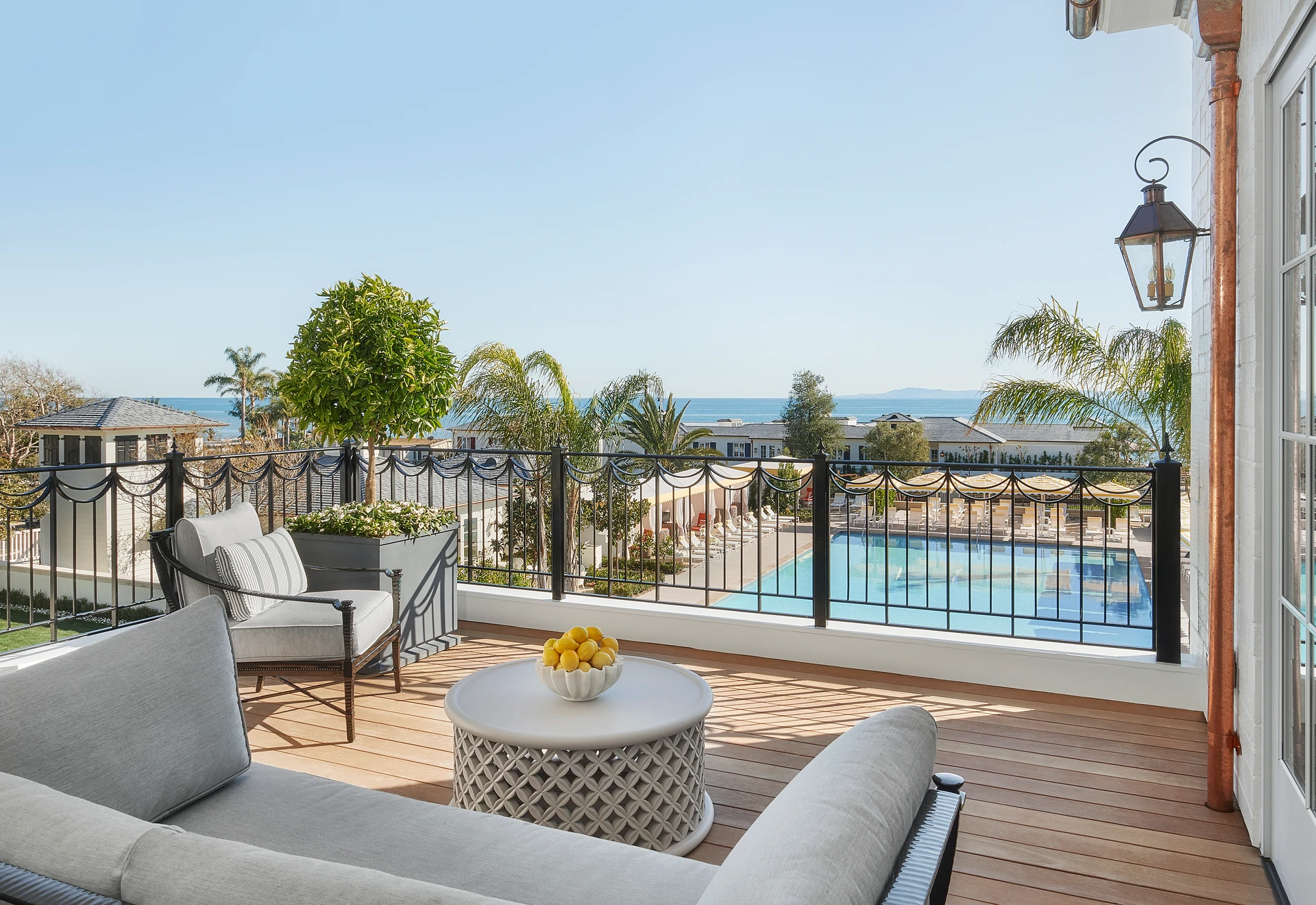 View over the swimming pool to the ocean from the Manor Suite balcony at Rosewood Miramar Beach.