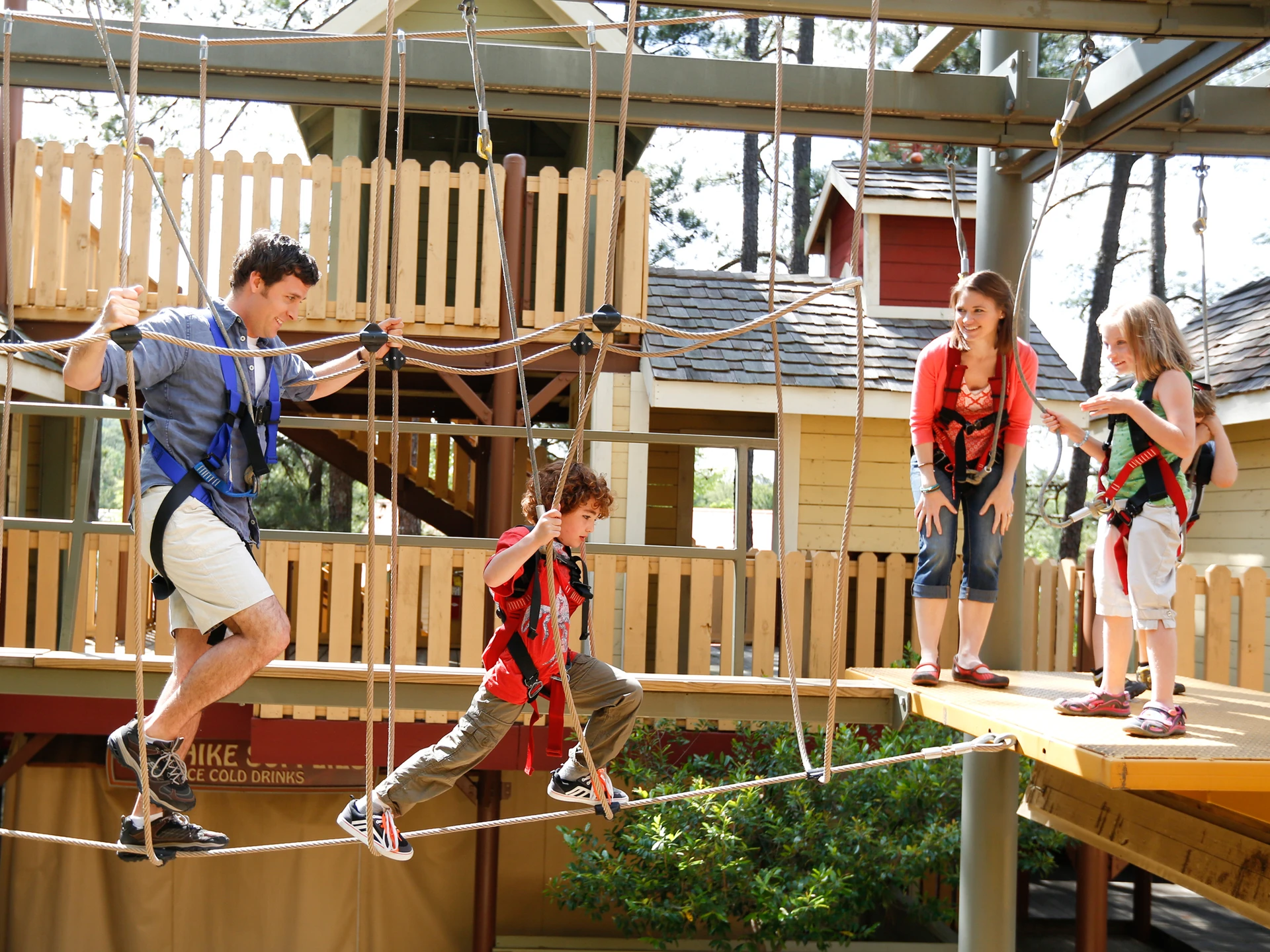A family tackles an elevated ropes course at Stone Mountain Park in Atlanta.