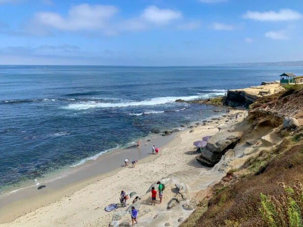 People enjoy La Jolla Shell Beach on a sunny summer day.