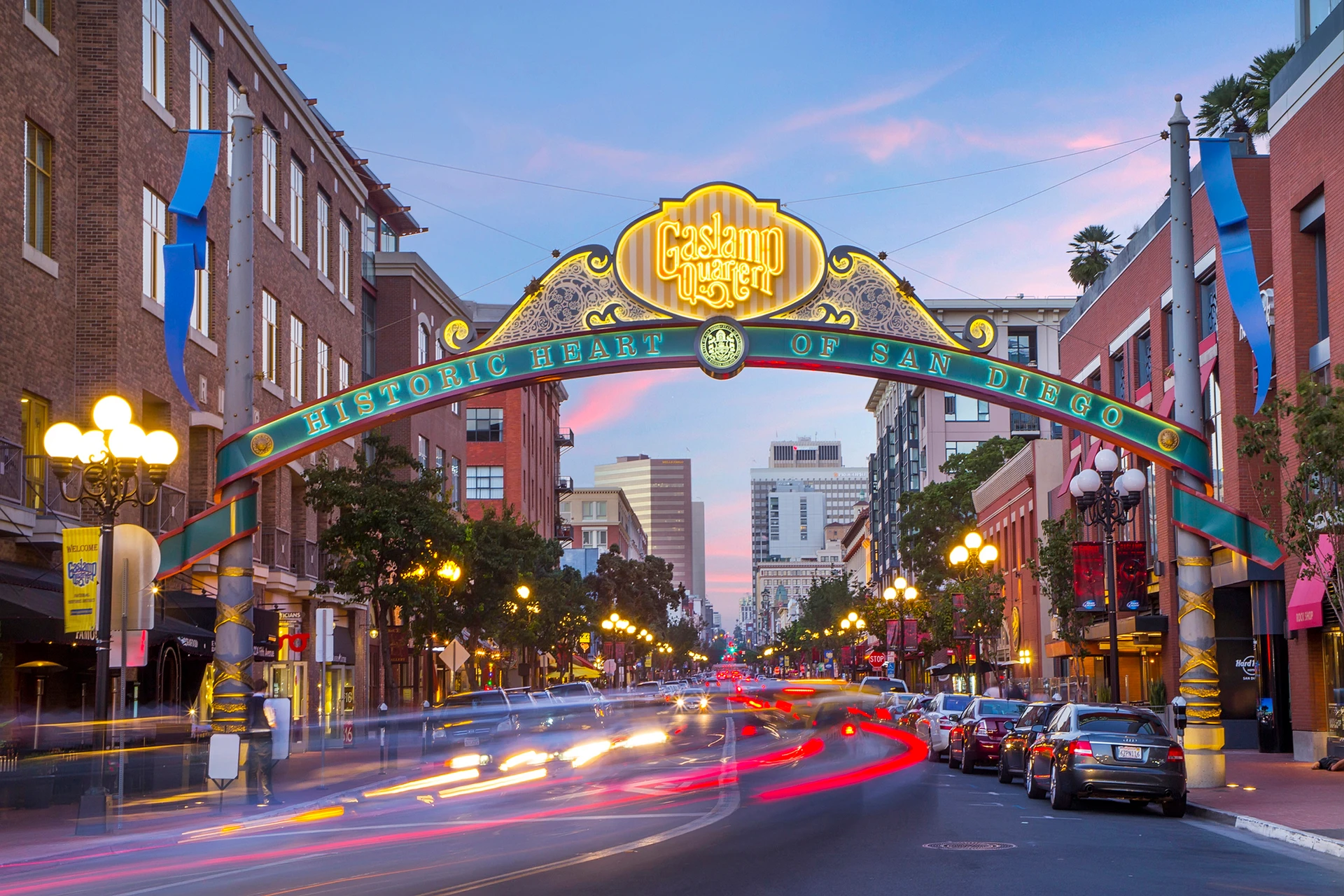 Cars whiz under the Gaslamp Quarter sign in downtown San Diego