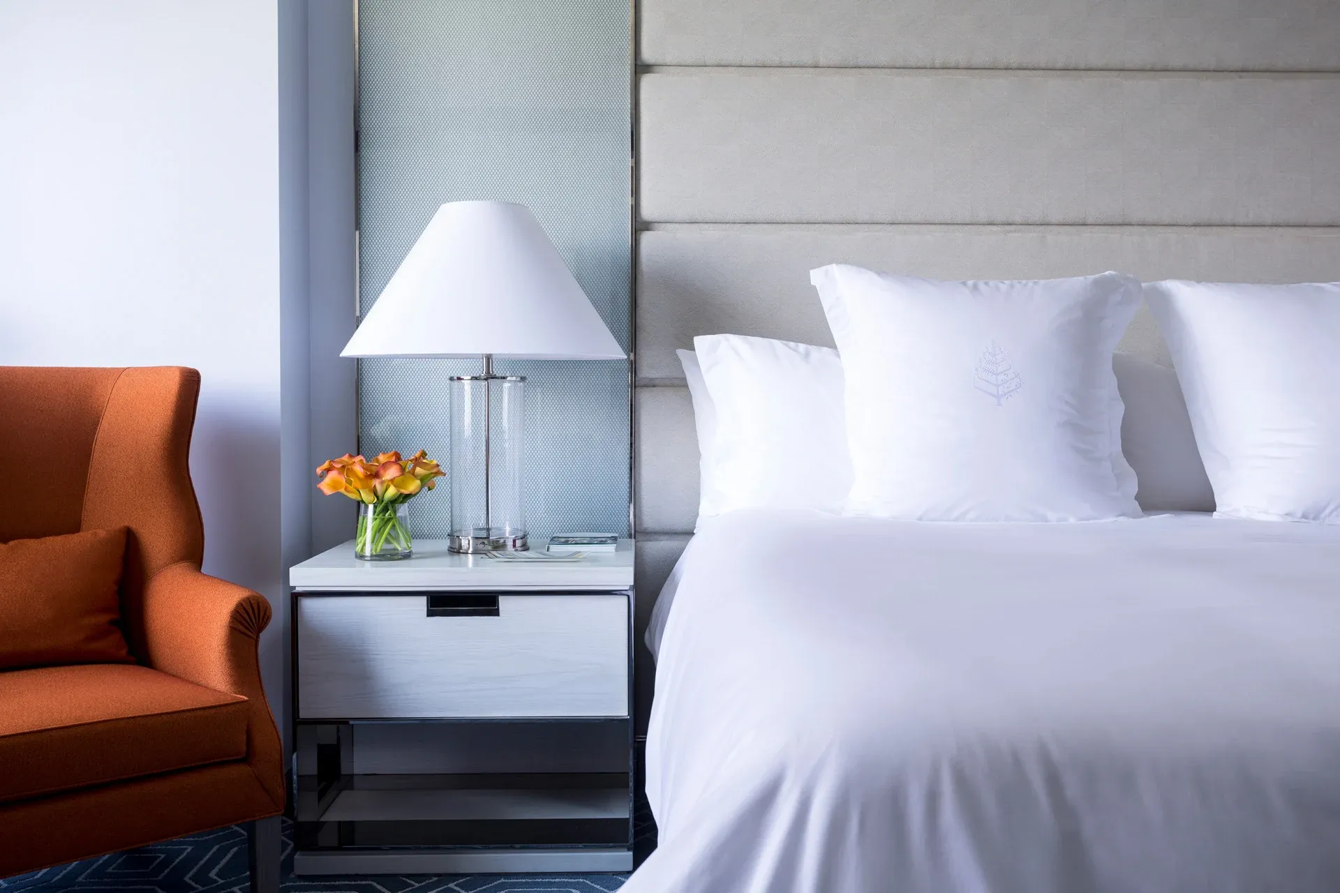 View of the bed and nightstand in a standard guest room.