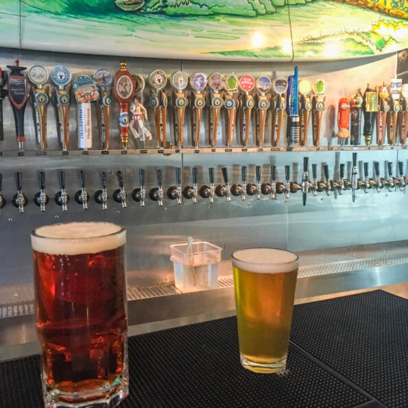 Two beers sit on the bar at Pizza Port in Ocean Beach San Diego.