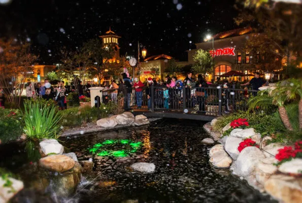 Shoppers enjoy festivities at night during the holiday season.
