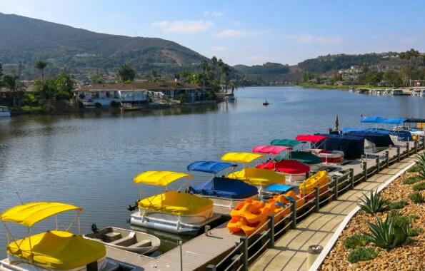 Colorful boats, kayaks and paddle boats stored on the lake &mdash; the best things to do in San Marcos, CA.