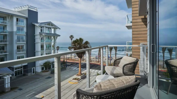 Balcony with two chairs facing The Seabird Resort and the ocean.