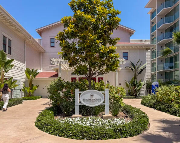 A woman walks toward the Shore House main entrance.