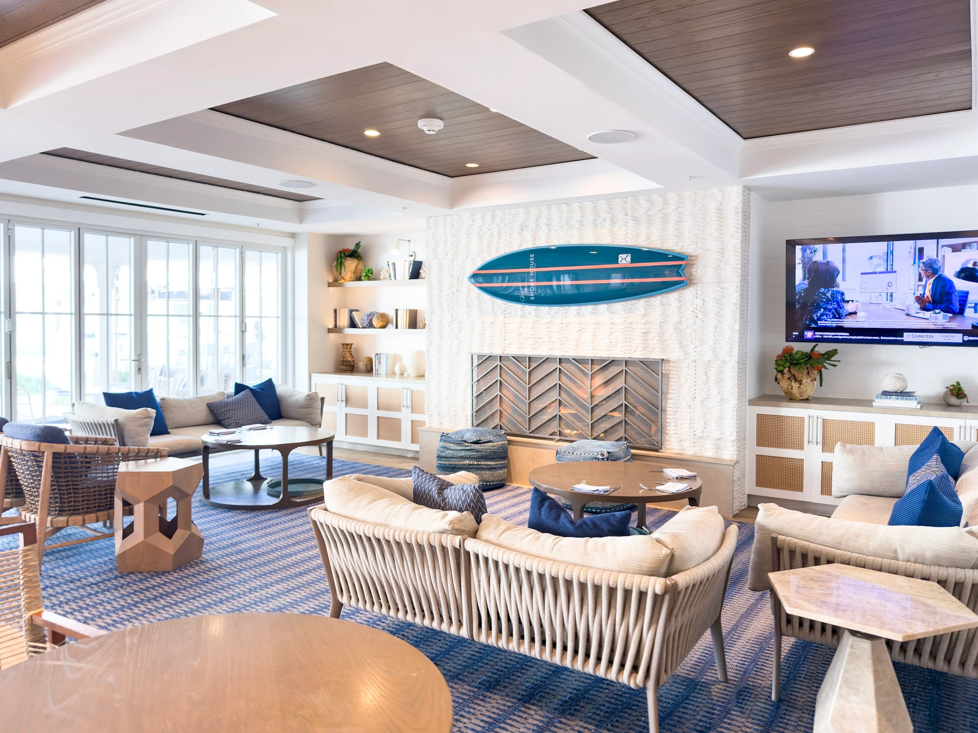Lobby seating area with TV with a coastal vibe at Shore House at The Del