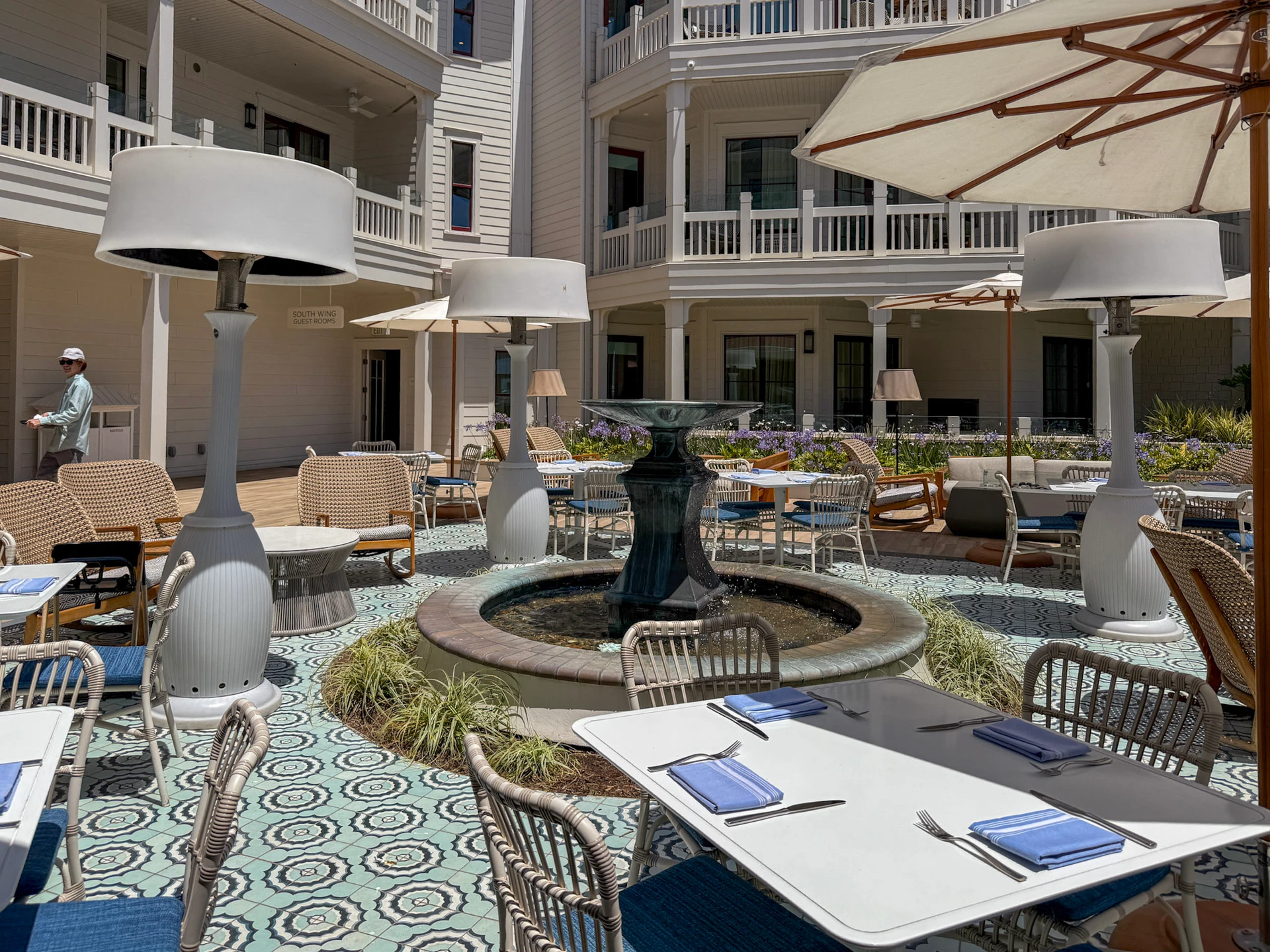 Shore House Bistro outdoor tables shaded by umbrellas.