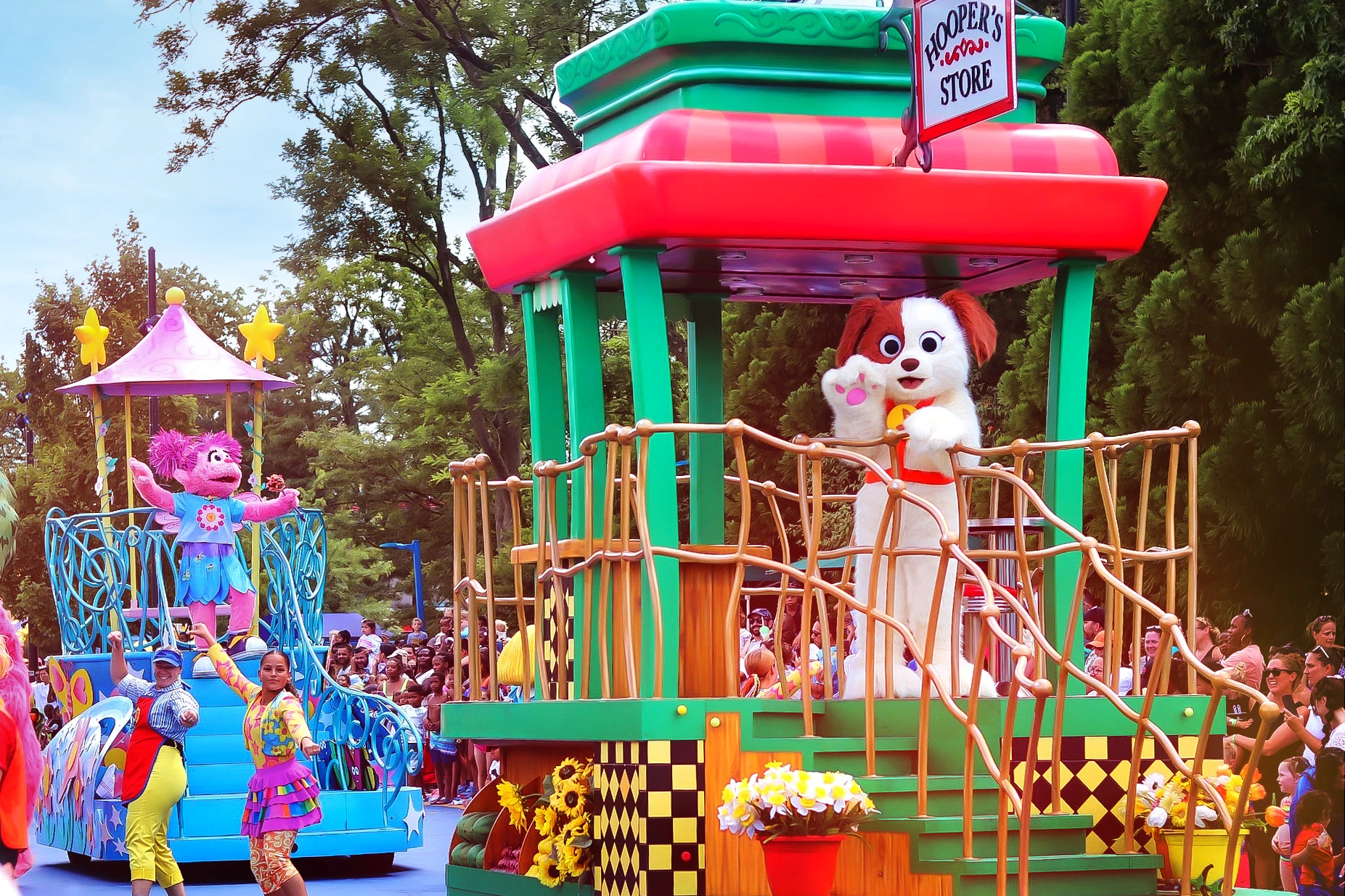 Tango, Elmo's rescue dog, waves to guests from a float in the parade.
