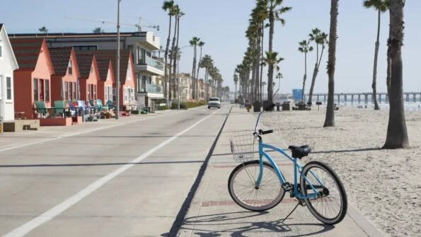 A bicycle parked on the sidewalk at Breakwater Bay Beach in Oceanside, CA. 