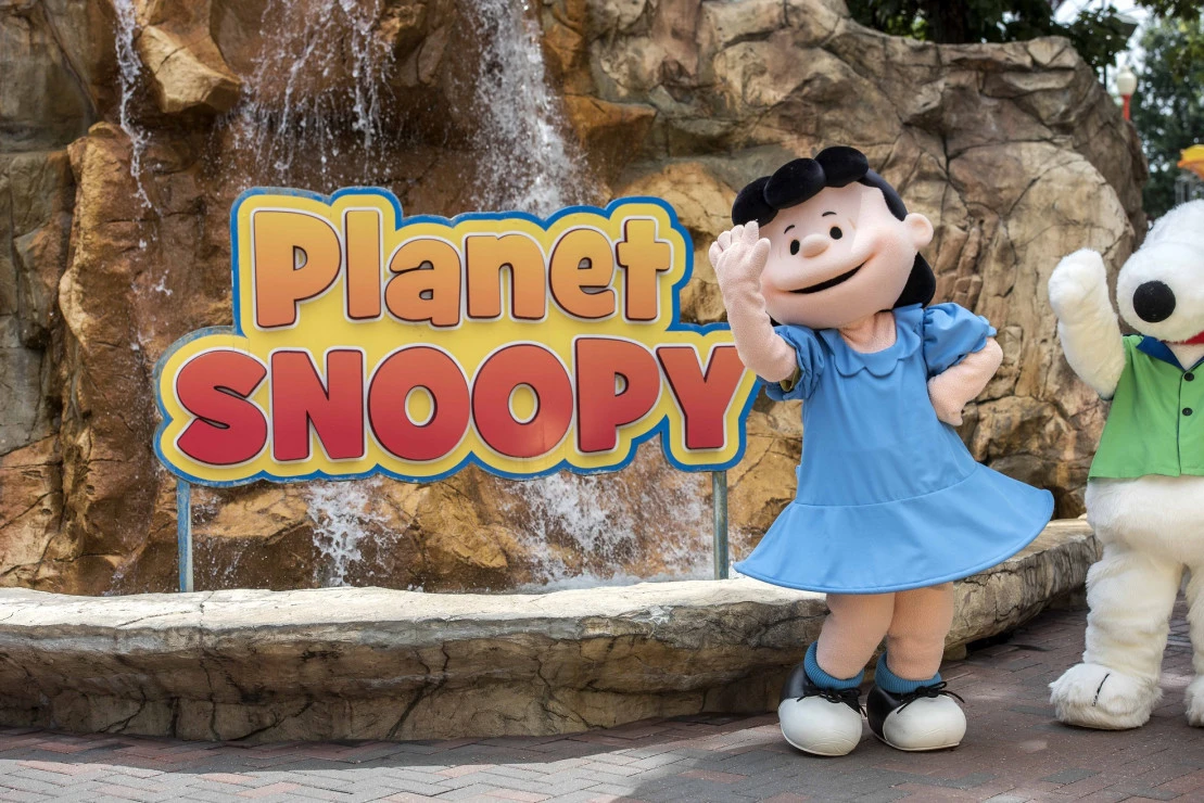 Planet Snoopy mascots waving at worlds of fun
