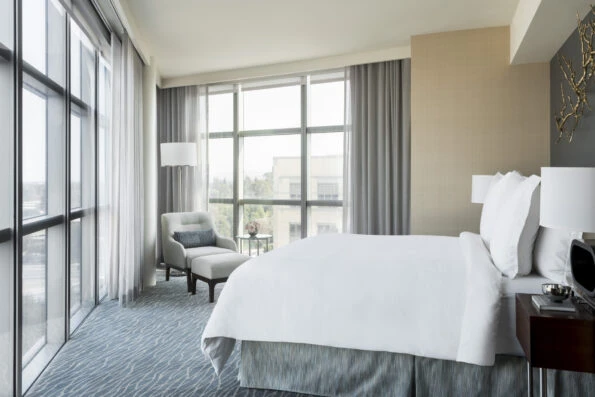 Executive Suite bedroom with corner floor to ceiling windows.