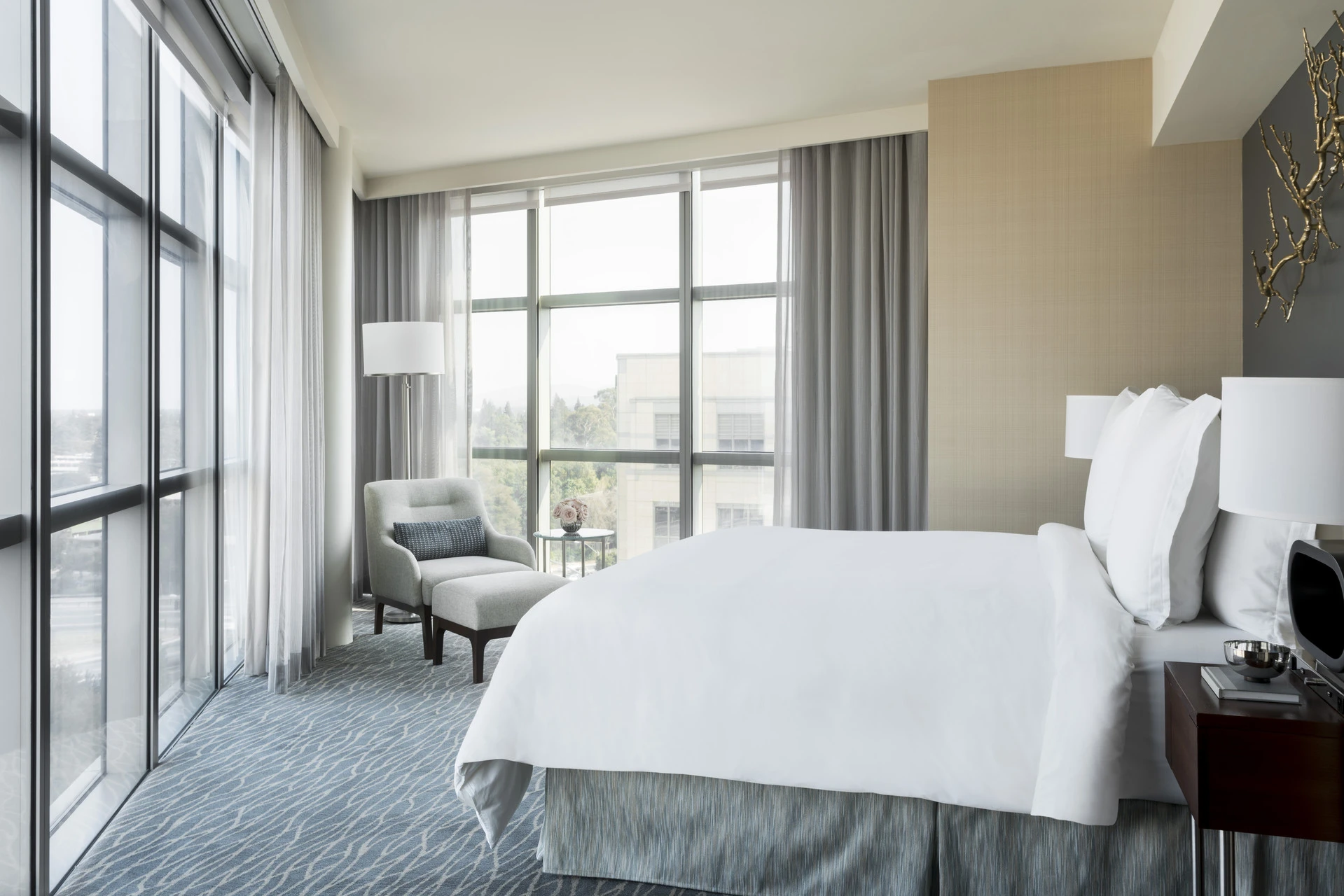 Executive Suite bedroom with corner floor to ceiling windows.