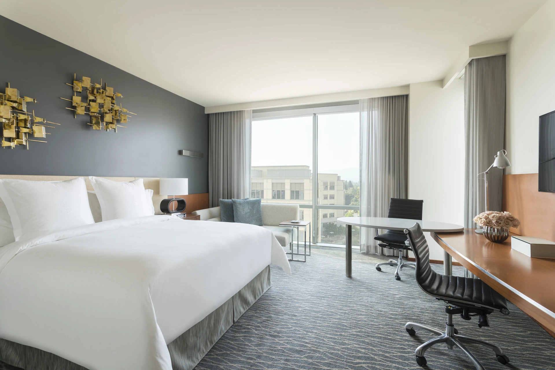 Premier King room interior with muted gray and natural tones.