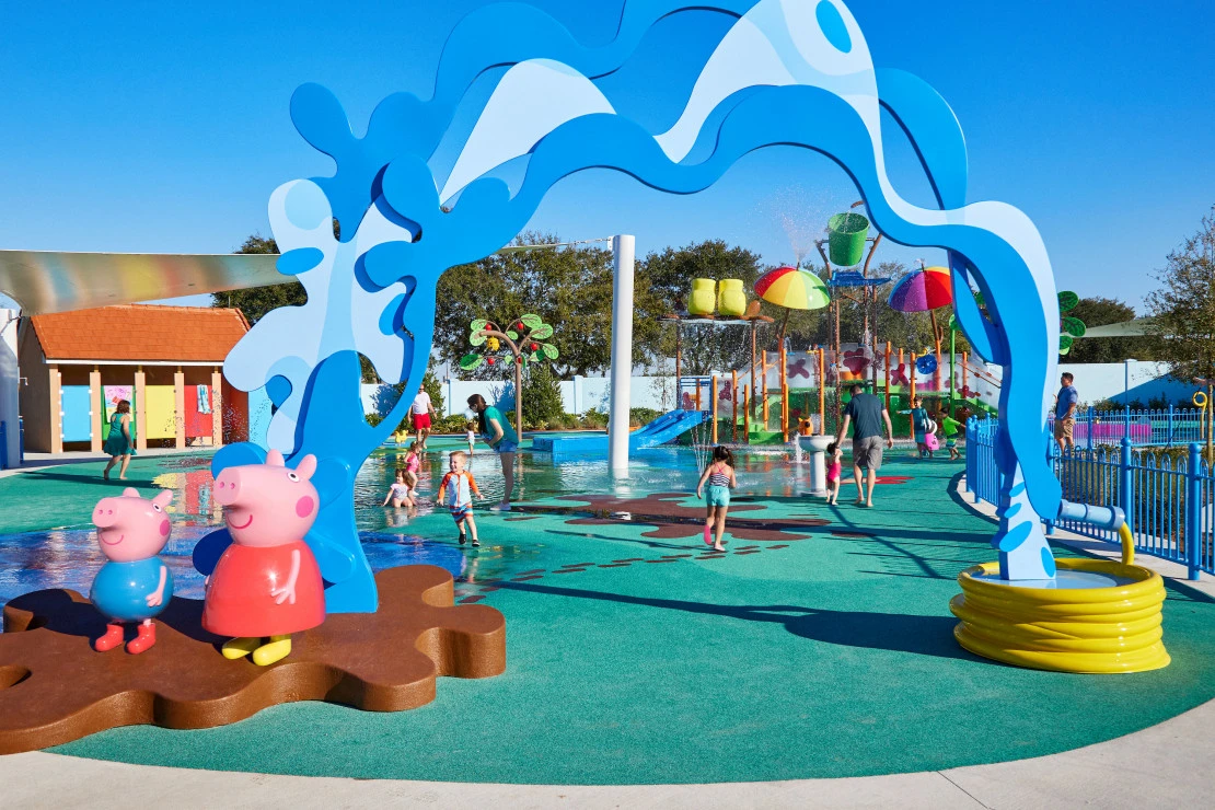 Kids run around a splash pad at Peppa Pig Florida.