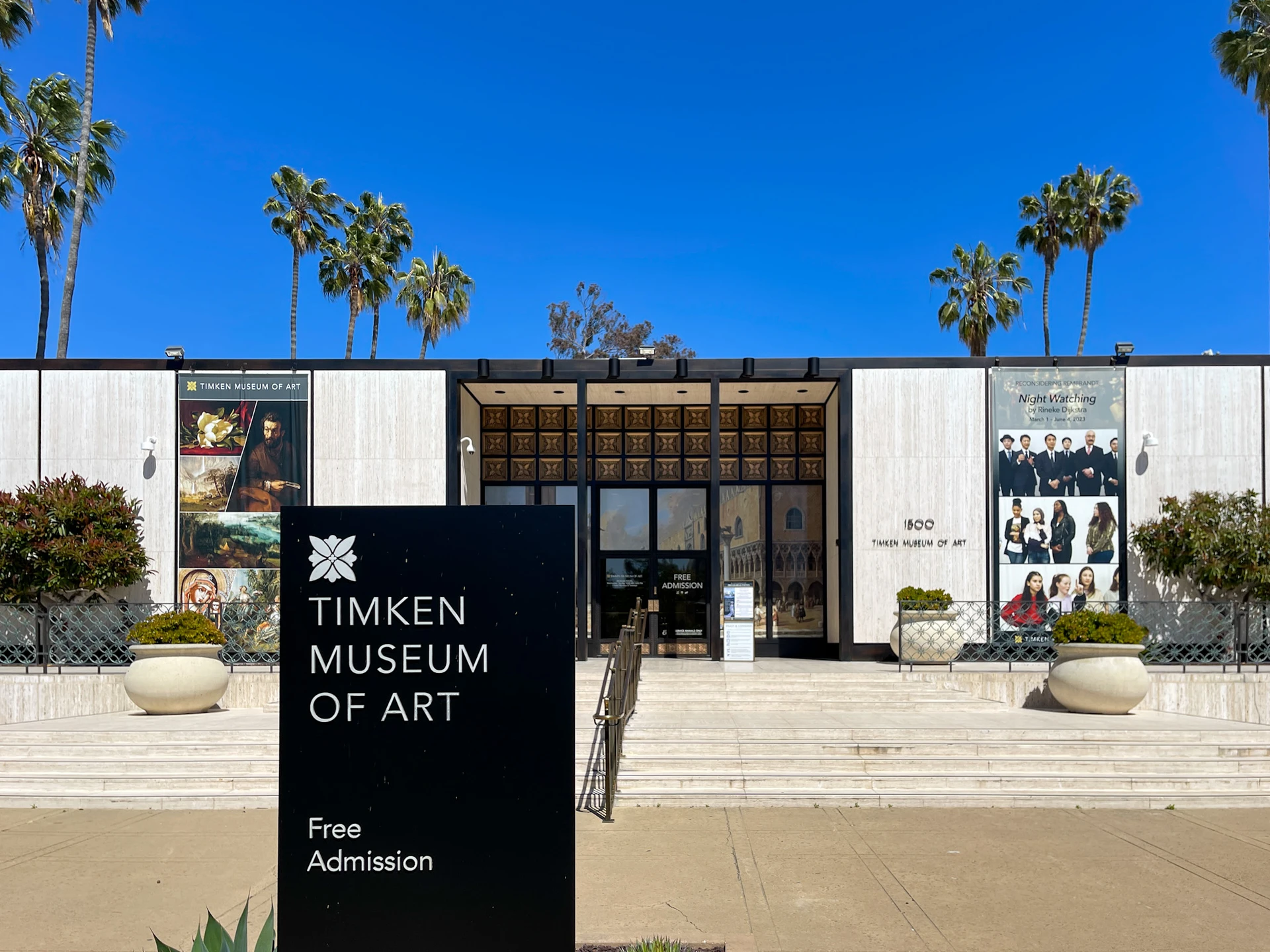 Exterior of Timken Museum of Art in San Diego with blue sky and palm trees in the background.