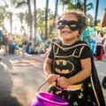 Little girl dressed as Batgirl trick or treating at SeaWorld Halloween event