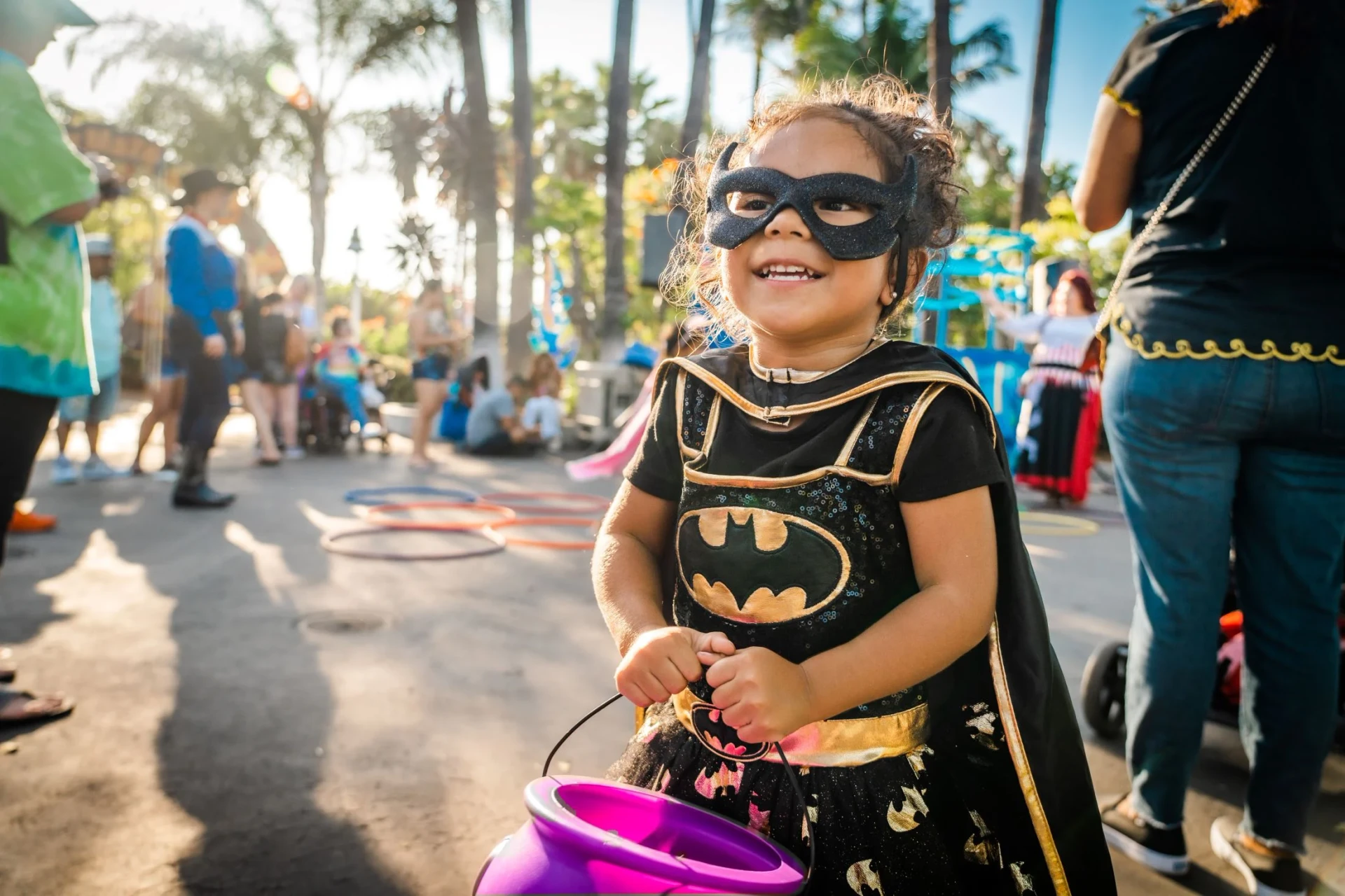 Little girl dressed as Batgirl trick or treating at SeaWorld Halloween event