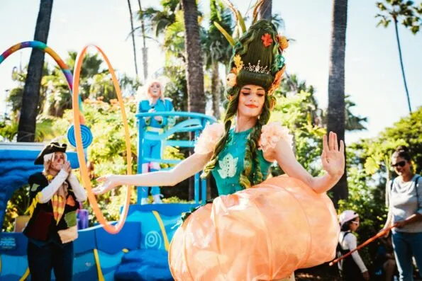 A woman dressed in a pumpkin costume dancing at San Diego Seaworld Halloween event