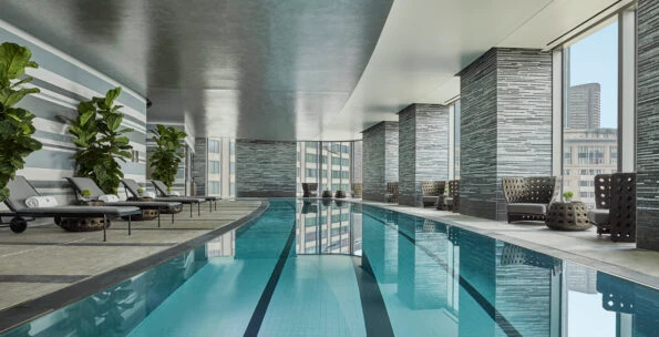 Interior view of the curved swimming pool at Four Seasons Hotel One Dalton Street Boston.