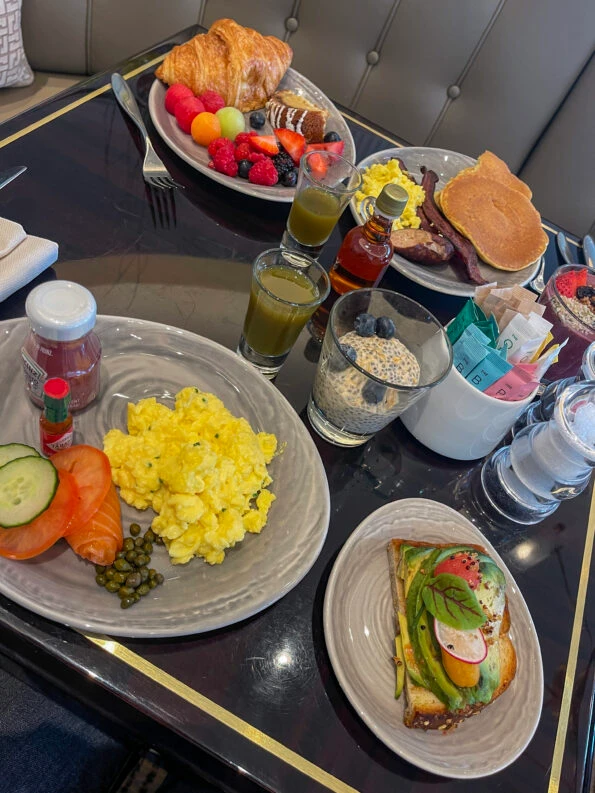 A table with multiple breakfast plates at One + One restaurant at Four Seasons One Dalton Street Boston
