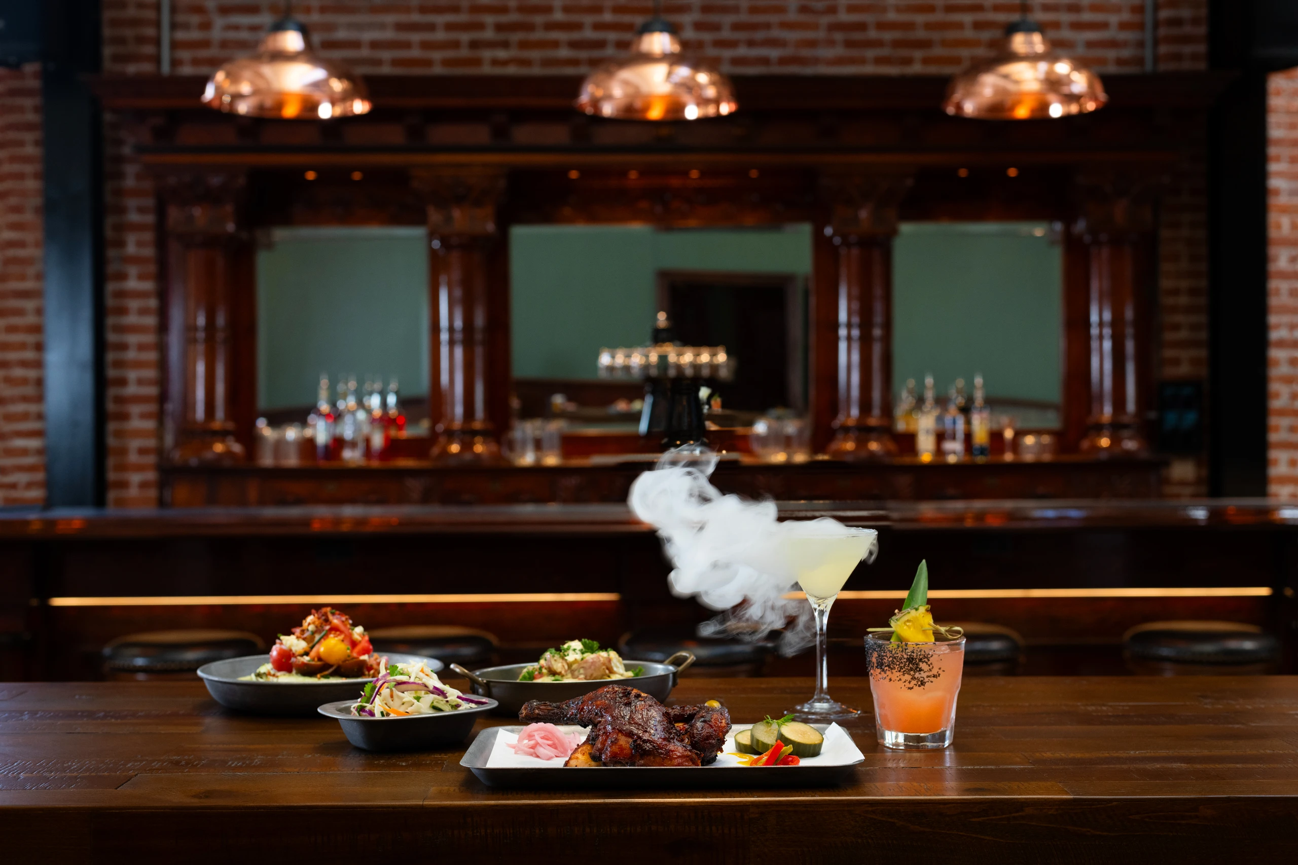 Food and cocktails on the bar inside The Laundry at Hotel del Coronado