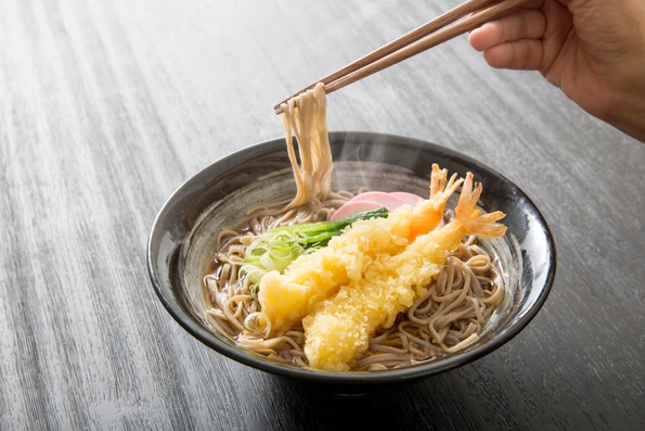 A bowl of hot soba noodle soup, which is a New Year's Eve traditional Japanese food.