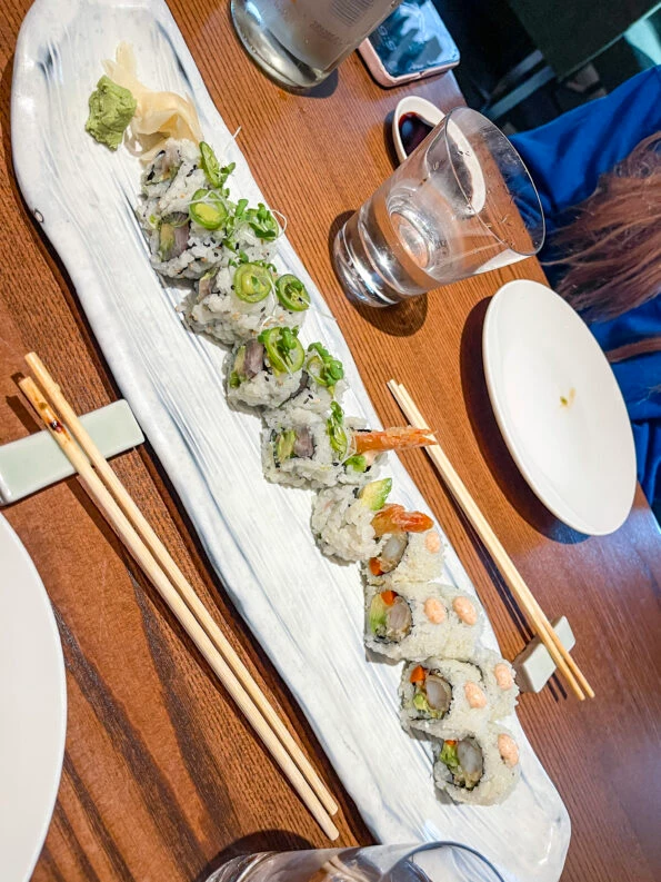 Two different sushi rolls on a long oval plate at Zuma Boston