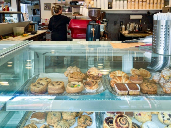 The bakery case full of scones, cinnamon rolls and other baked goods at Brick and Bell La Jolla.