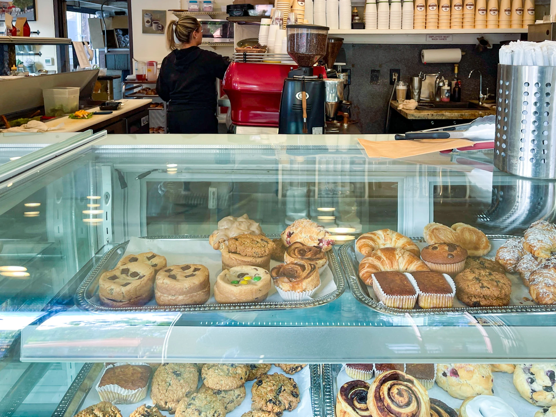 The bakery case full of scones, cinnamon rolls and other baked goods at Brick and Bell La Jolla.