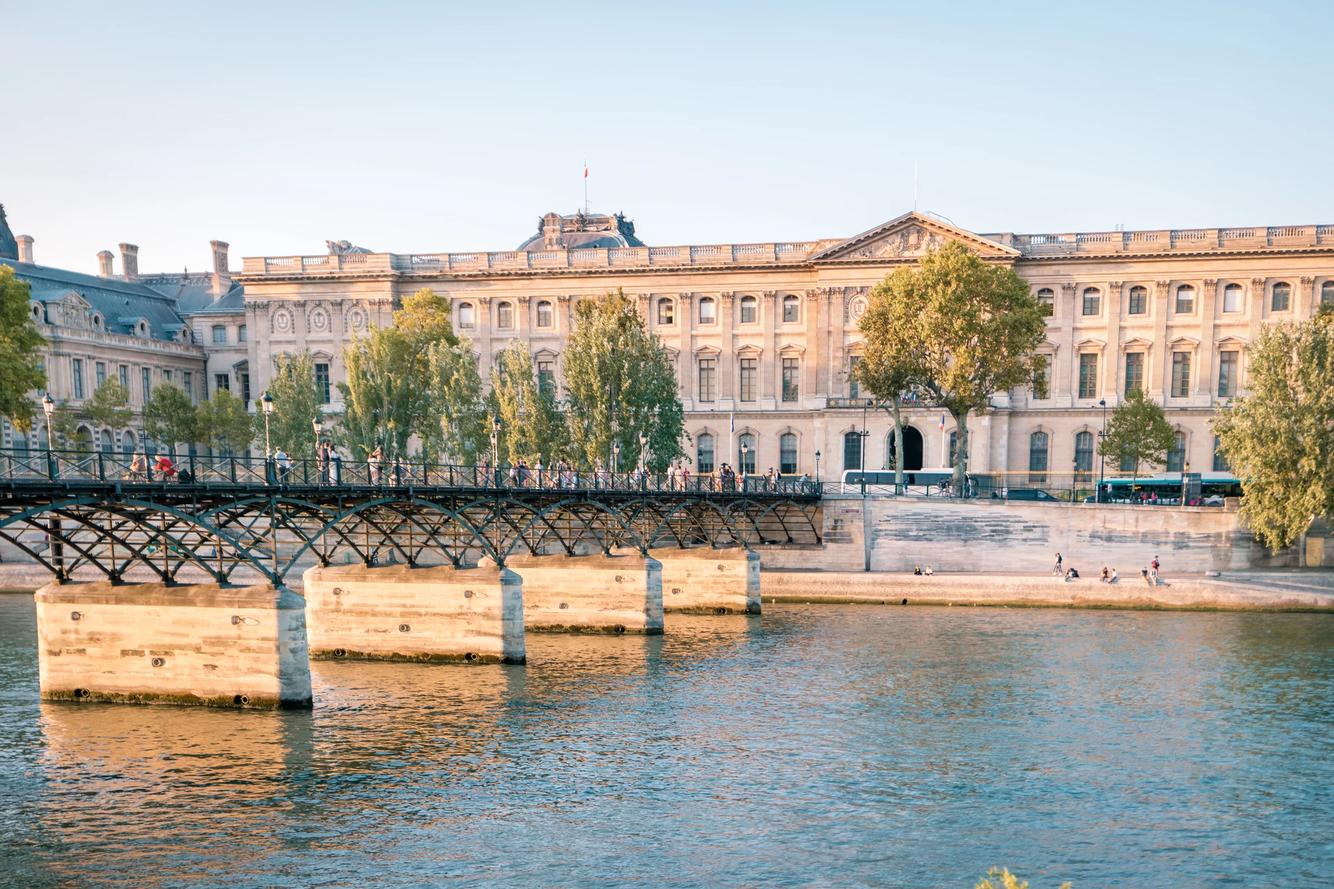 People enjoy the bridge in front of Musee de l'Orangerie Museum in Paris