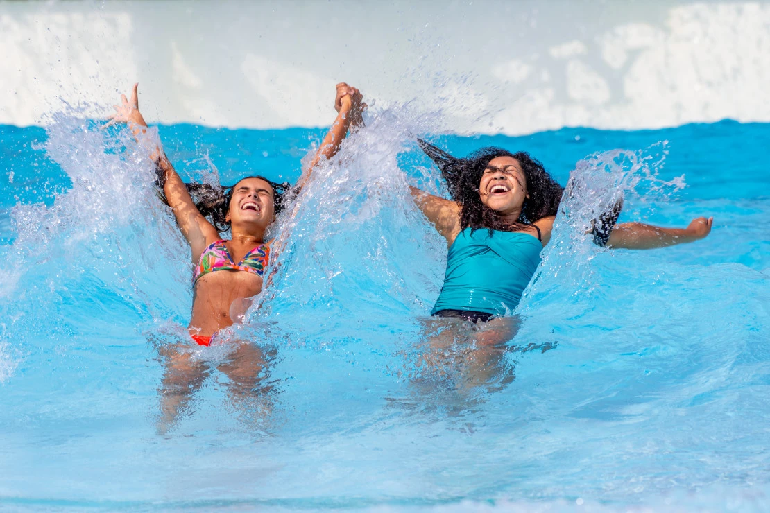 Two girls play in a wave pool at Noah's Ark.