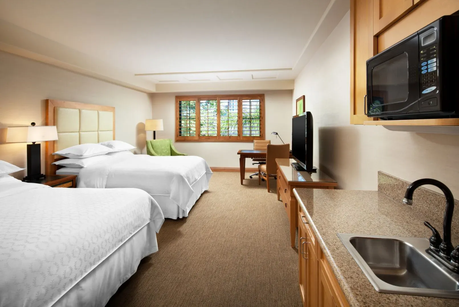 A two bed guest room with kitchenette interior.