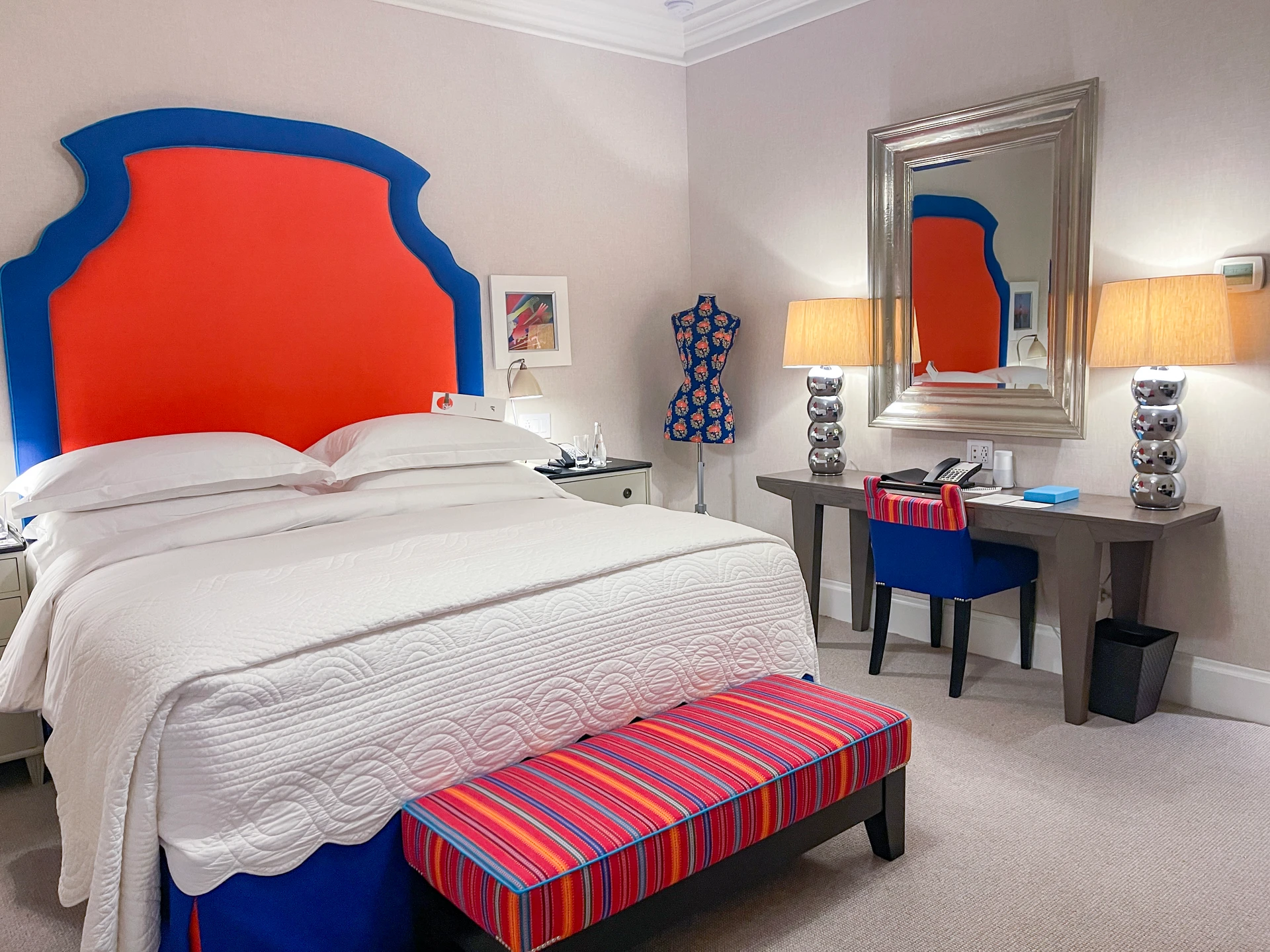 A Deluxe room interior with oranges, blues, and whites at Crosby Street Hotel.