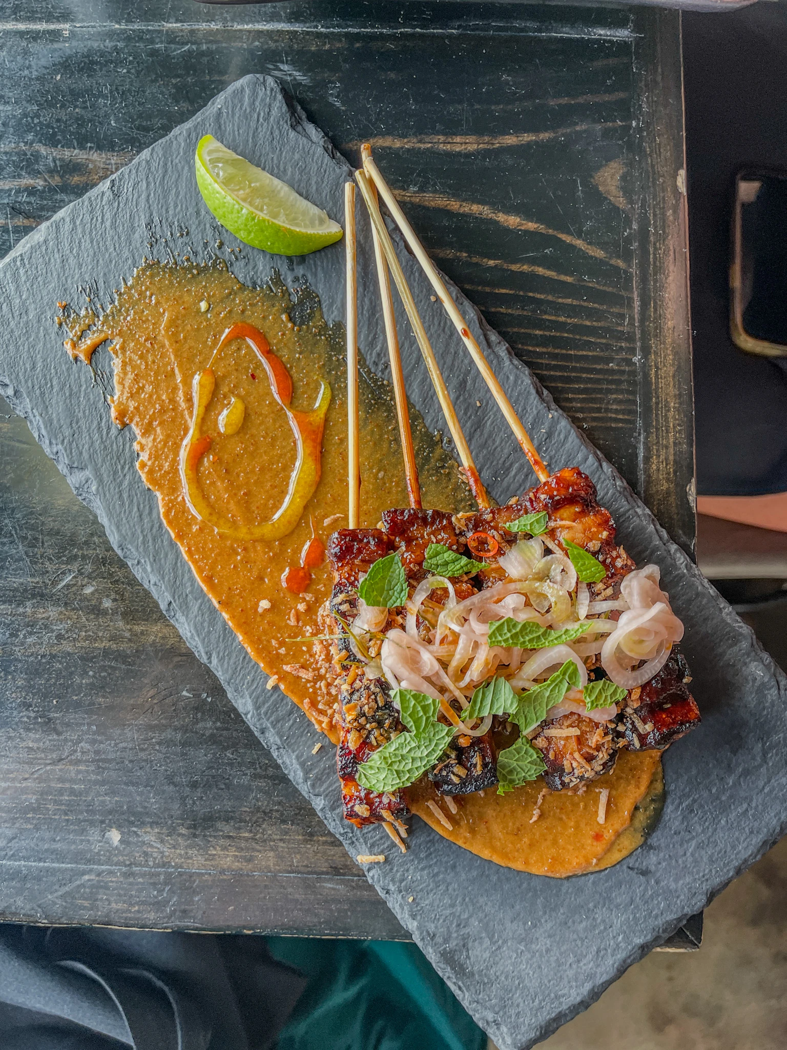 Skewers on a grey platter at Dija Mara in Oceanside.