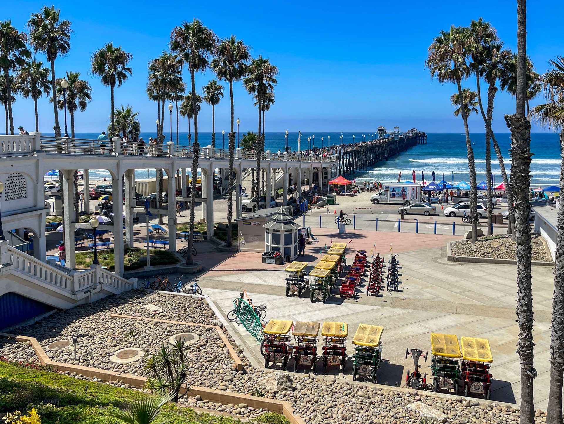 Bike rental shop and Oceanside pier on a sunny day.
