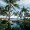 View of the pool and palm trees out to the beach at Four Seasons Lanai.