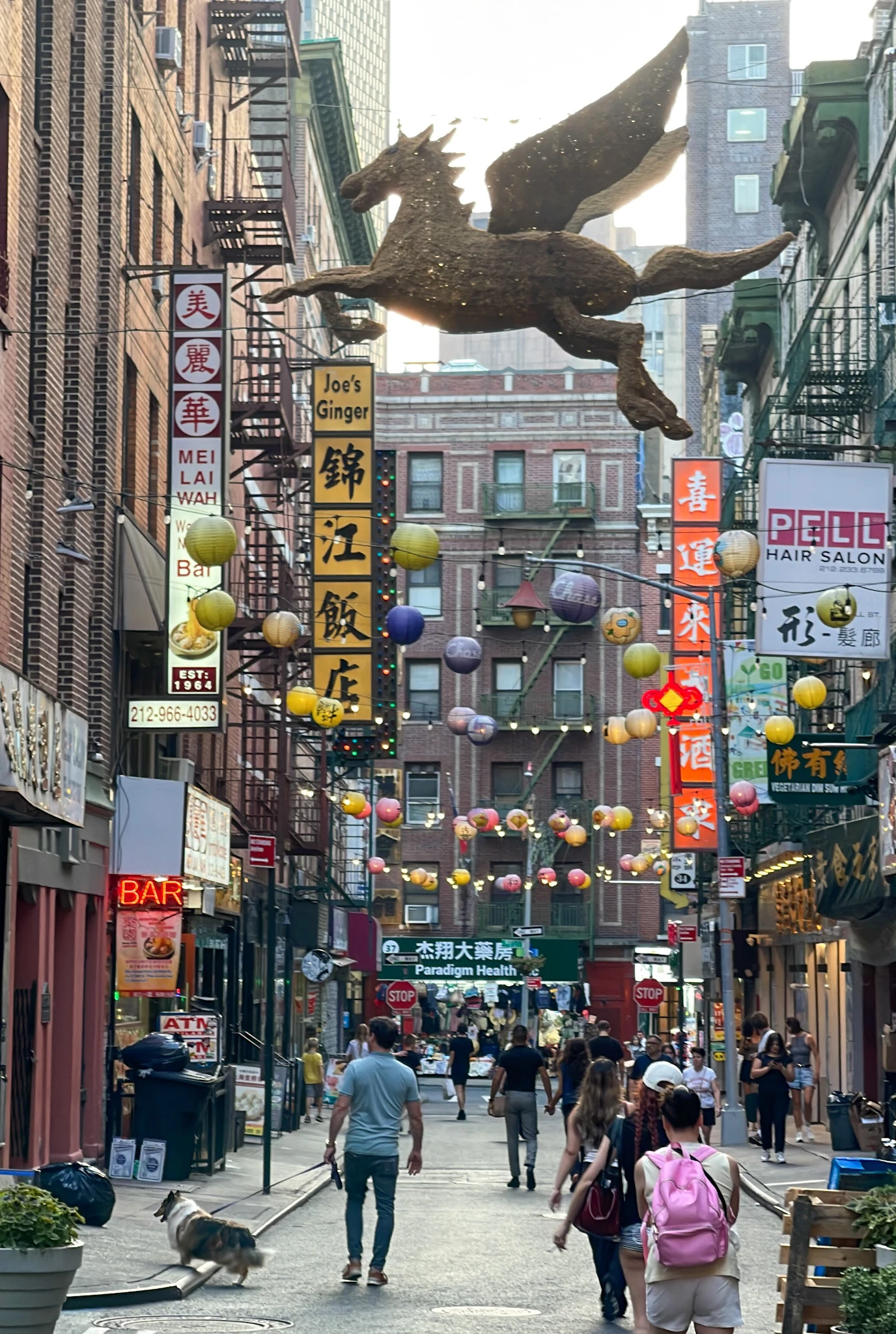 People walk along Bayard Street in Chinatown NYC.