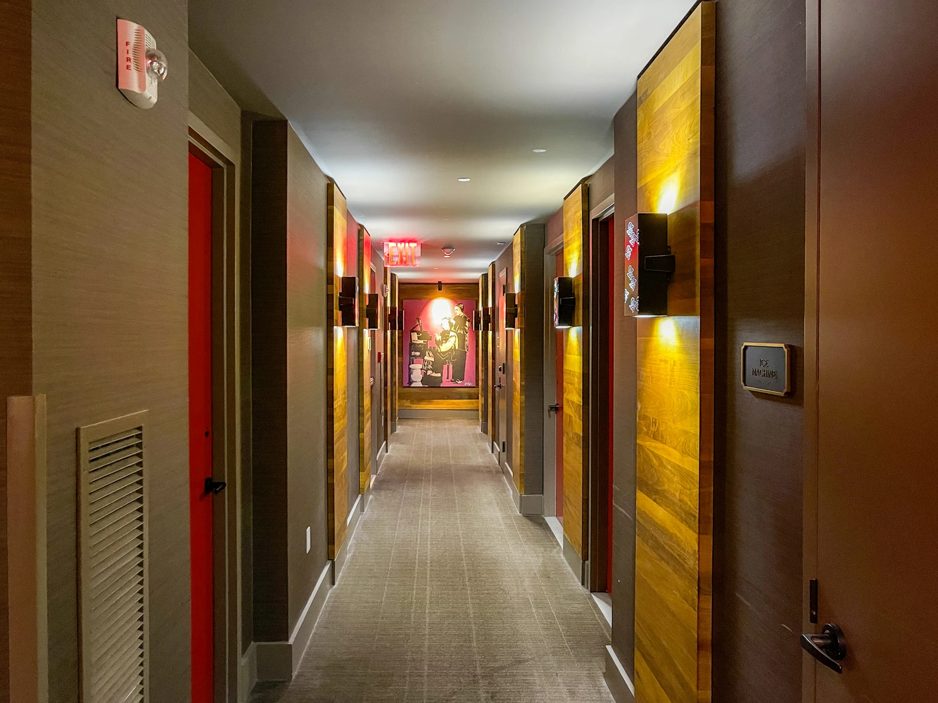 The hallway to our room with red hotel room doors and Asian accents.