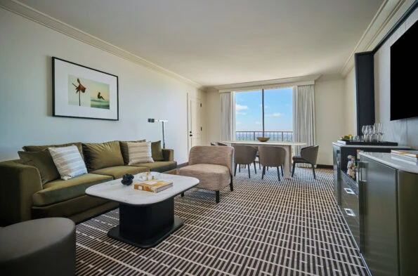 Living room with table in Deluxe One Bedroom Suite