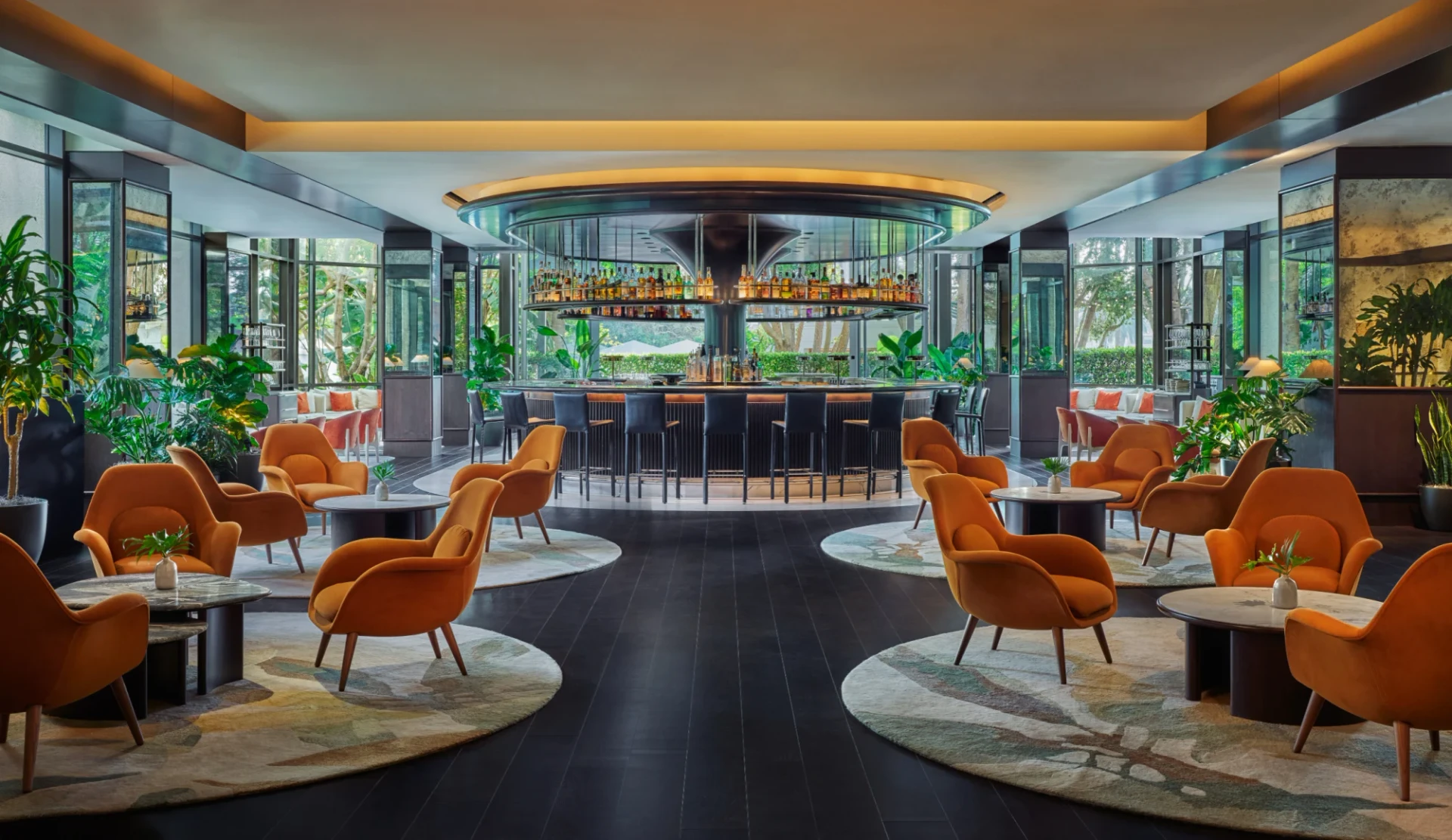 Bar Pendry during the day with its round bar and orange chairs.
