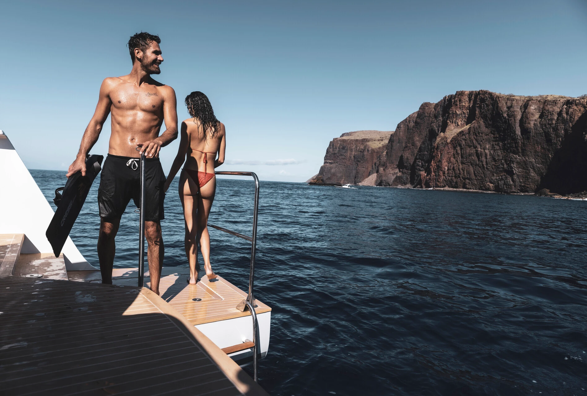 a man and woman sailing in the ocean