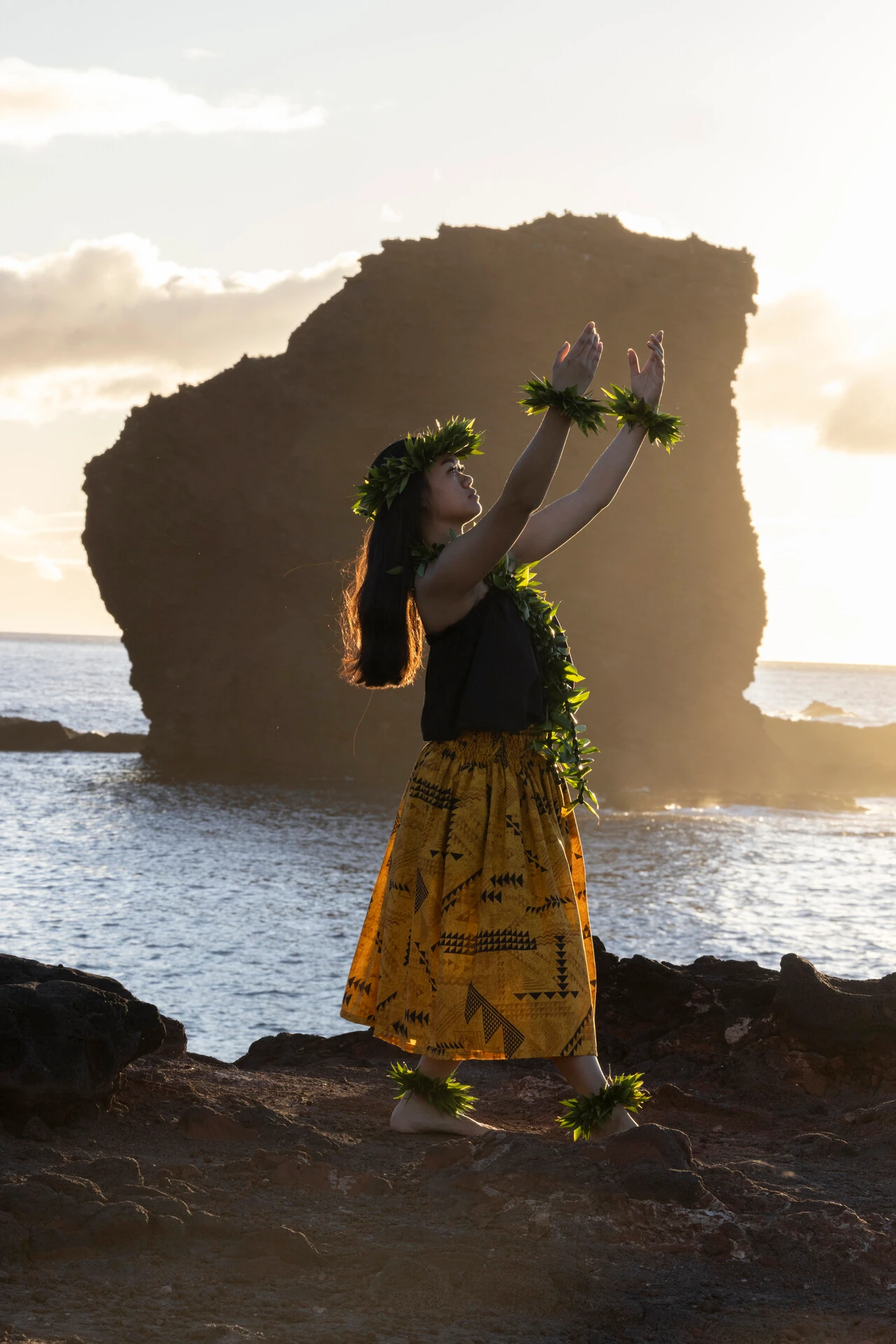 a girl doing hawaiian dance at the shore